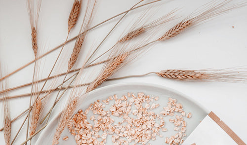 Scattered oatmeal and the oat plant stems.