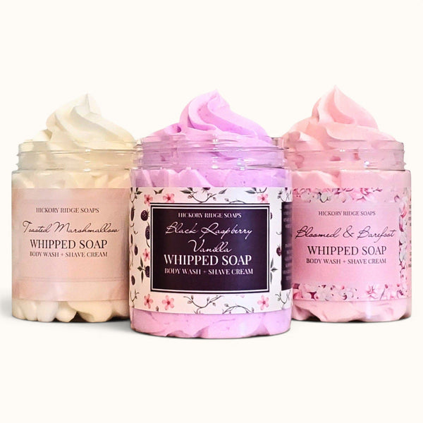 Three jars of whipped soap with visible labels on a white background