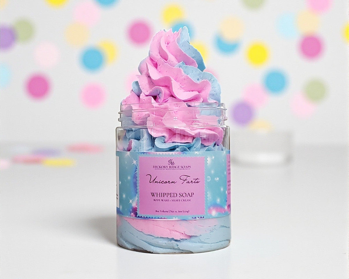 Jar of whipped soap with pink and blue colors against a colorful polka dot background