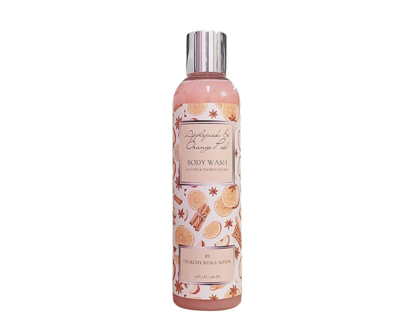 Body wash bottle with cinnamon and orange design on a white background