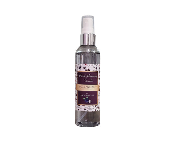 Fragrance mist bottle with decorative label on a white background