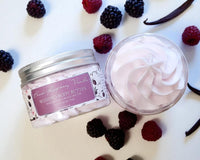 Black Raspberry Vanilla whipped body butter with berries and vanilla bean on a light background