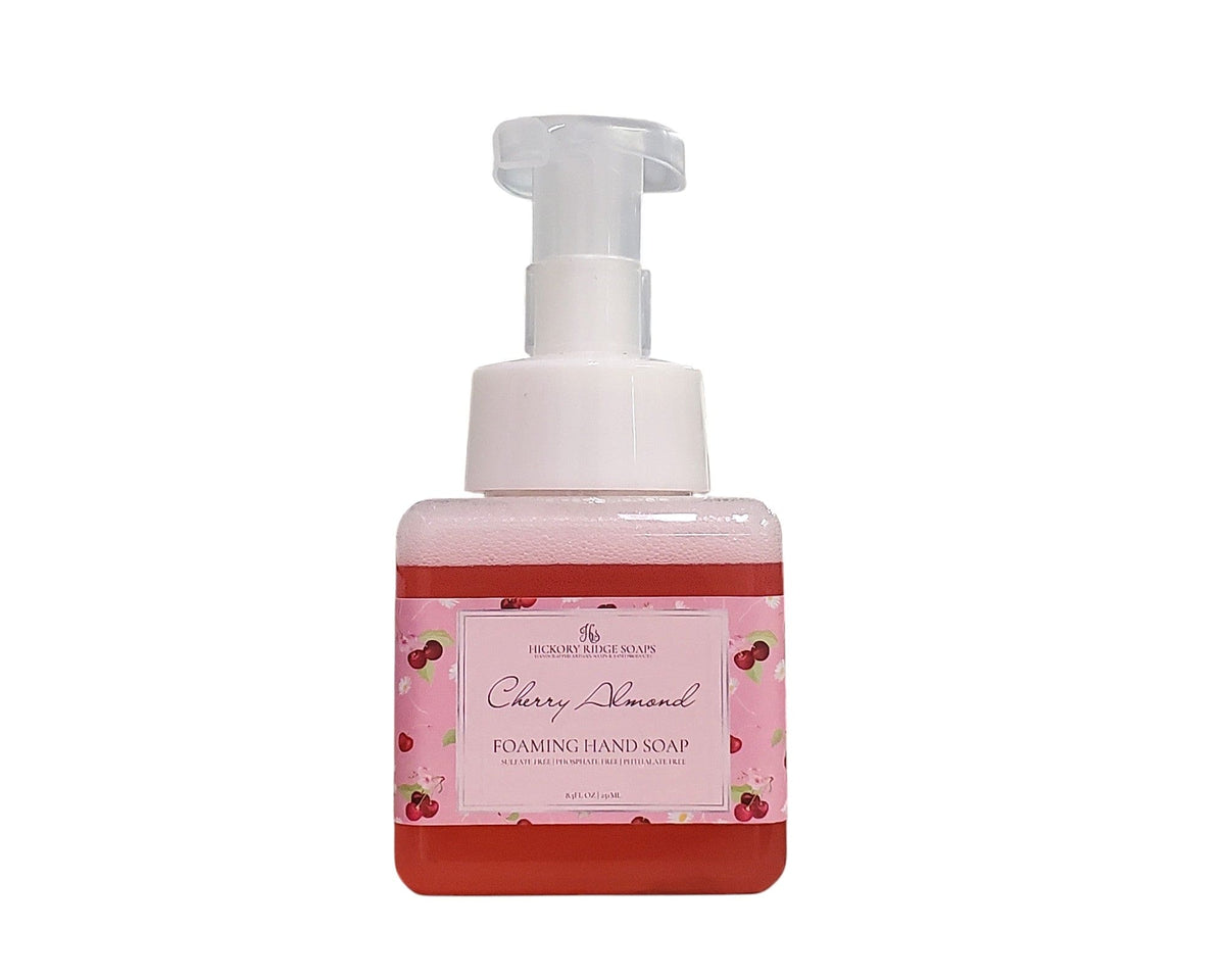 Foaming hand soap bottle with cherry almond scent on a white background