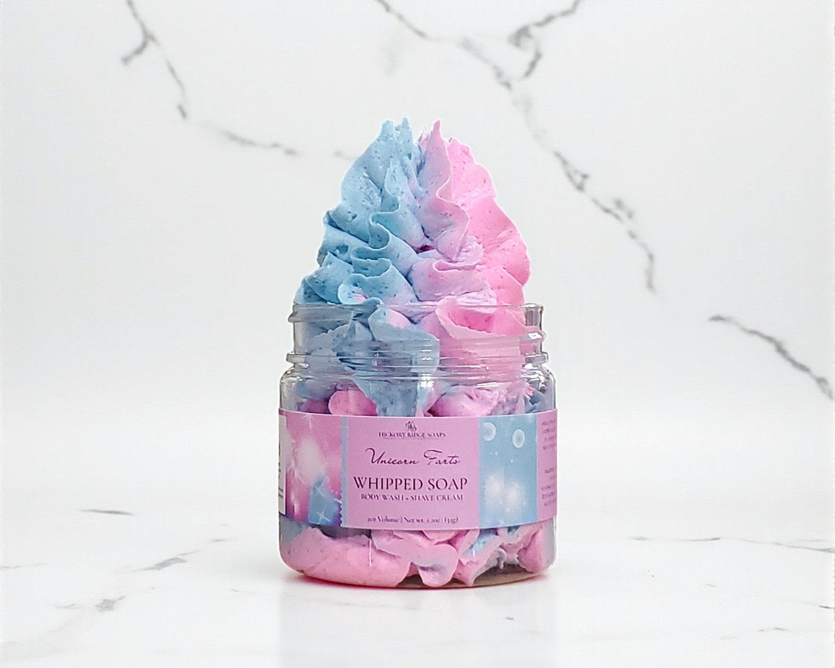 Jar of pink and blue whipped soap on a marble surface