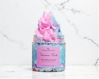 Jar of 'Unicorn Farts' whipped soap with a colorful top on a marble background