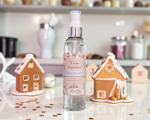 Fragrance mist bottle with gingerbread house decorations on a festive background