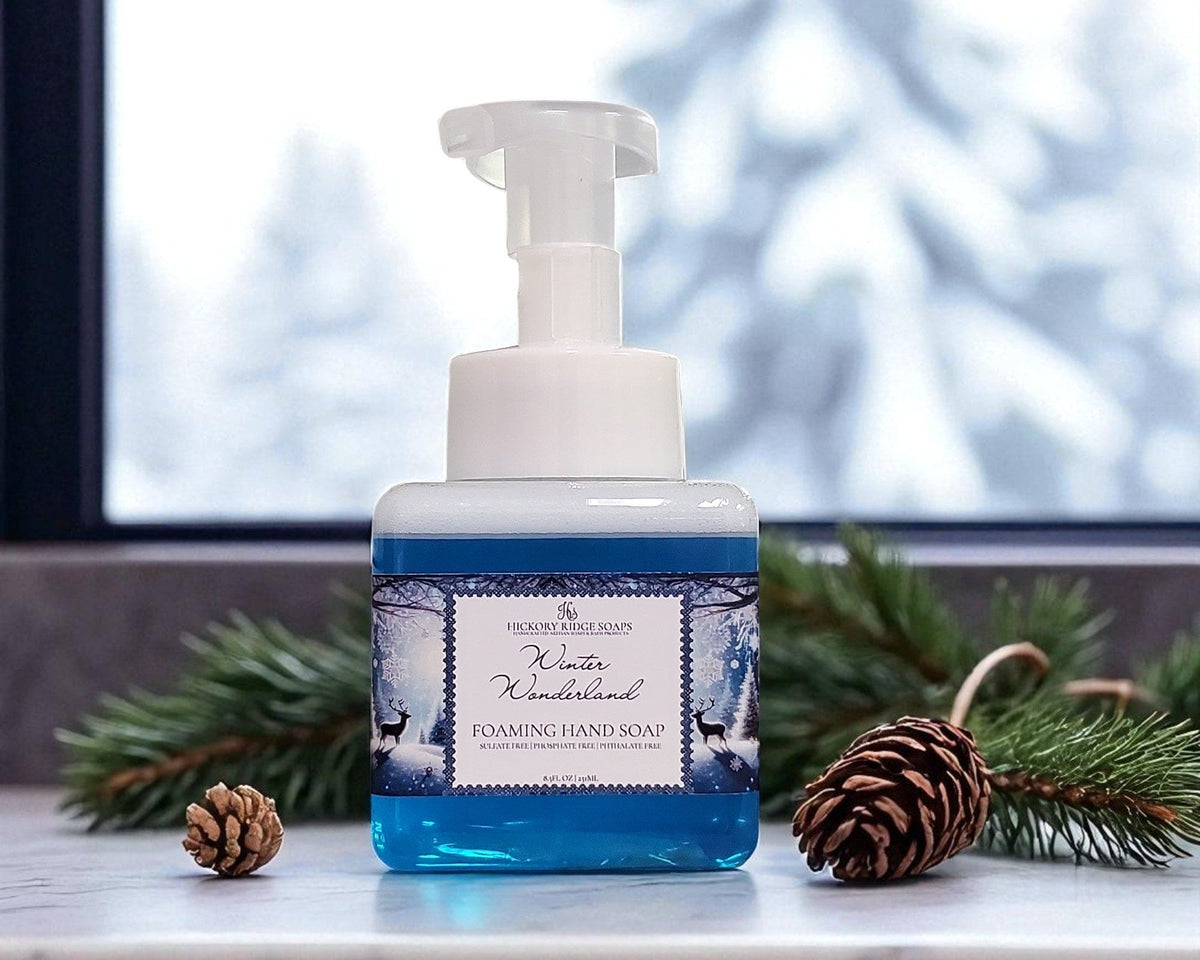 Foaming hand soap bottle with 'Winter Wonderland' label on a surface with decorative elements.