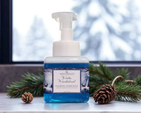 Foaming hand soap bottle with 'Winter Wonderland' label on a surface with decorative elements.