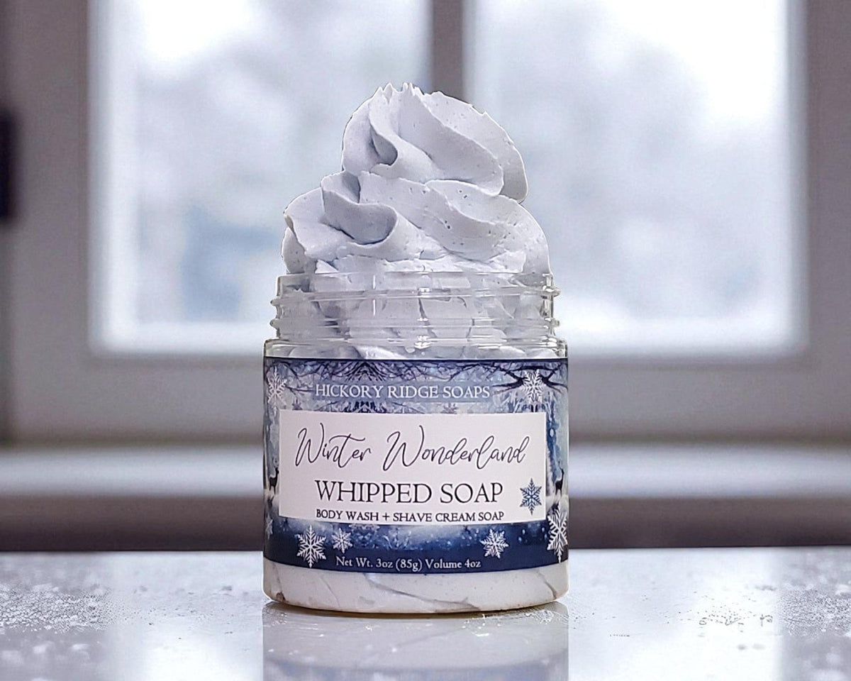 Jar of whipped soap with a label on a reflective surface