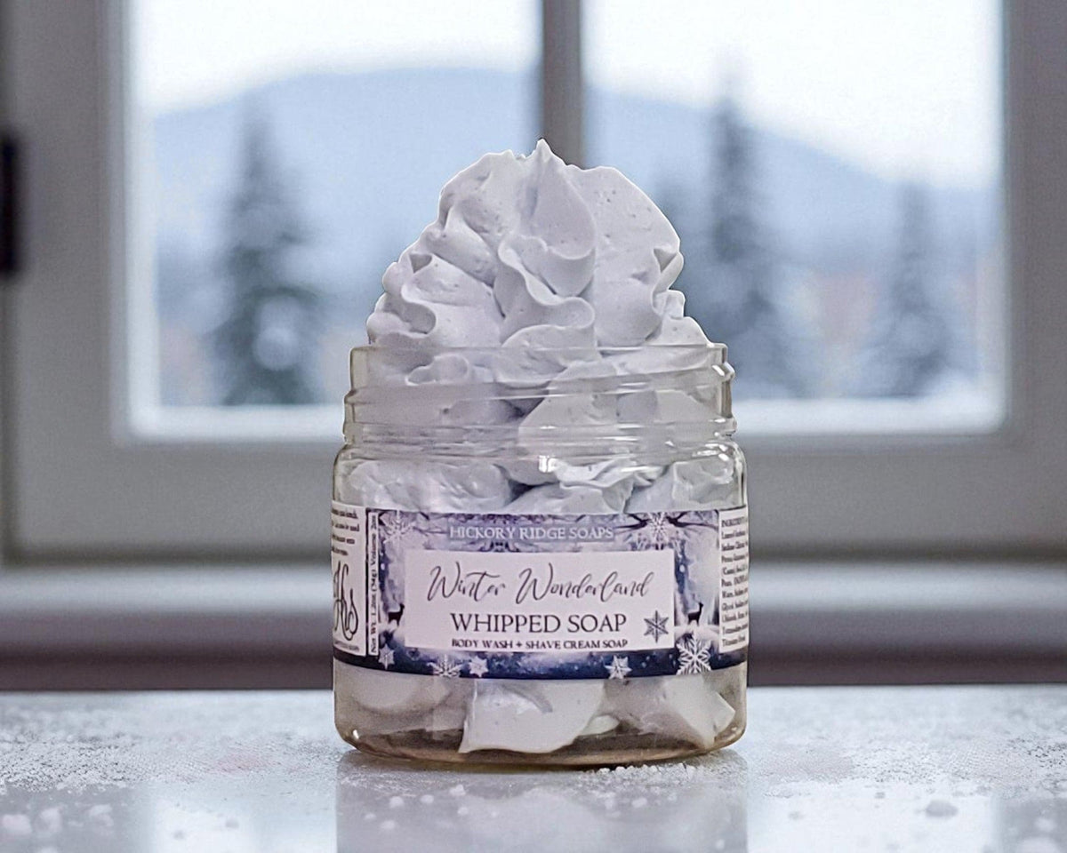Jar of whipped soap with a label on a reflective surface